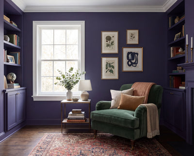 Die Wandfarbe Cobalt Husk in königsblauem Ton prägt diesen DIY-renovierten Wohnbereich mit Sessel, Bücherwand und ruhiger Atmosphäre – mit  der Renovierungsbox von re-box.